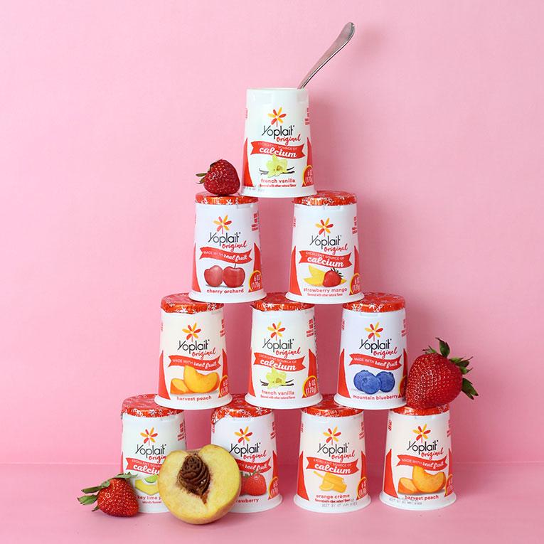 Twitter post featuring a pyramid of 10 cups of various Yoplait Original flavors.